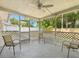 Screened porch area with lattice detailing and three chairs at 1390 S Hillcrest Ave, Clearwater, FL 33756