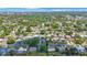 Expansive aerial view showcasing a peaceful residential neighborhood with lush green trees and well-maintained homes at 1410 Lime St, Clearwater, FL 33756