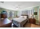 Bedroom with a queen sized bed, ceiling fan and large window at 1410 Lime St, Clearwater, FL 33756