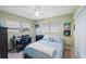 Comfortable bedroom with a ceiling fan, two windows, and a bed made up with blue bedding at 1410 Lime St, Clearwater, FL 33756