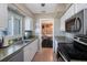 Kitchen sink next to a large window, next to stainless steel appliances and white cabinets at 1410 Lime St, Clearwater, FL 33756