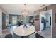 Open-concept dining and living room with chandelier lighting and view into kitchen at 1410 Lime St, Clearwater, FL 33756