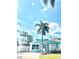Inviting blue home featuring lush palm trees and a well-maintained front yard at 1734 Maryland Ne Ave, St Petersburg, FL 33703