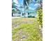 Charming blue bungalow with a white picket fence and well-manicured landscaping at 1734 Maryland Ne Ave, St Petersburg, FL 33703