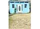 Exterior view of a light blue shed with a white door and lattice trim at 1734 Maryland Ne Ave, St Petersburg, FL 33703