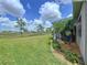 A spacious backyard with a screened-in lanai overlooks the peaceful golf course at 1803 Pacific Dunes Dr, Sun City Center, FL 33573