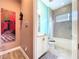 Charming bathroom with tiled shower over tub, modern vanity, and unique wall art at 1803 Pacific Dunes Dr, Sun City Center, FL 33573
