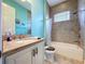 Bathroom featuring granite countertops, white cabinets, tile flooring, and decorative fixtures at 1803 Pacific Dunes Dr, Sun City Center, FL 33573