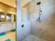Modern bathroom featuring a tiled shower with a rain shower head and glass partition at 1803 Pacific Dunes Dr, Sun City Center, FL 33573