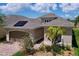 Charming single-story home featuring a brick driveway, two-car garage, and well-maintained landscaping at 1803 Pacific Dunes Dr, Sun City Center, FL 33573