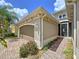 The exterior showcases a garage, side entrance, brick walkway and attractive landscaping at 1803 Pacific Dunes Dr, Sun City Center, FL 33573
