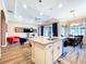 Spacious kitchen island with a sink overlooking the dining and living areas, perfect for entertaining in this home at 1803 Pacific Dunes Dr, Sun City Center, FL 33573