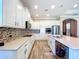 Elegant kitchen featuring white cabinetry, granite countertops, and stainless steel appliances at 1803 Pacific Dunes Dr, Sun City Center, FL 33573