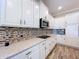 Beautiful kitchen with white cabinets, granite countertops, and modern stainless steel appliances at 1803 Pacific Dunes Dr, Sun City Center, FL 33573