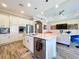 Modern kitchen with granite countertops, stainless steel appliances, and an open view to the living room area at 1803 Pacific Dunes Dr, Sun City Center, FL 33573