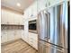 Modern kitchen with stainless steel appliances, white cabinets, and granite countertops at 1803 Pacific Dunes Dr, Sun City Center, FL 33573