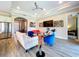 Open-concept living room with tray ceiling, wood-look tile floors and bright, modern decor at 1803 Pacific Dunes Dr, Sun City Center, FL 33573