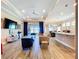 Open-concept living area with modern décor, wood-look tile floors, and natural light from sliding glass doors at 1803 Pacific Dunes Dr, Sun City Center, FL 33573