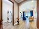 Cozy living room open to laundry room with stacked washer/dryer; views to the exterior at 1803 Pacific Dunes Dr, Sun City Center, FL 33573