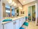 Bathroom featuring double sinks, white cabinetry, and a walk-in closet at 1803 Pacific Dunes Dr, Sun City Center, FL 33573