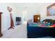 Comfortable bedroom featuring a large mirror, dresser and TV at 1803 Pacific Dunes Dr, Sun City Center, FL 33573
