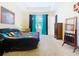 Bright bedroom with a large window and curtains, featuring a quilted bedspread at 1803 Pacific Dunes Dr, Sun City Center, FL 33573