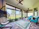Inviting screened-in patio features a hanging chair, comfortable seating, and scenic views at 1803 Pacific Dunes Dr, Sun City Center, FL 33573