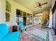 Inviting screened-in patio with brick flooring, ceiling fan, modern decor, and outdoor seating at 1803 Pacific Dunes Dr, Sun City Center, FL 33573
