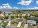 Aerial view showcasing a well-maintained home in a tranquil neighborhood near a lake at 186 Dan River Dr, Spring Hill, FL 34606