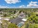 Gorgeous aerial view of home with screened-in pool, solar panels, and lush surrounding landscaping under a bright blue sky at 186 Dan River Dr, Spring Hill, FL 34606
