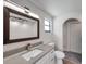 Modern bathroom featuring a white vanity and a dark framed mirror at 186 Dan River Dr, Spring Hill, FL 34606