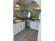 Bathroom featuring double sinks with granite countertop, white cabinets, and large mirrors at 186 Dan River Dr, Spring Hill, FL 34606