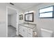 Bright bathroom featuring a white vanity with modern sink and mirror, along with toilet at 186 Dan River Dr, Spring Hill, FL 34606