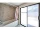 A tiled shower and bathtub with an adjacent sliding glass door for convenience at 186 Dan River Dr, Spring Hill, FL 34606
