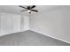 A lovely bedroom featuring a ceiling fan, carpeted floors, and a convenient closet at 186 Dan River Dr, Spring Hill, FL 34606