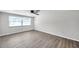 Light and airy bedroom featuring wood floors, a ceiling fan, and a large window at 186 Dan River Dr, Spring Hill, FL 34606