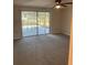 Bedroom with a sliding glass door leading to the pool area and a ceiling fan at 186 Dan River Dr, Spring Hill, FL 34606