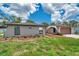Side view of a quaint home featuring arched windows and a well-manicured lawn at 186 Dan River Dr, Spring Hill, FL 34606
