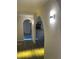Hallway featuring arches and wall lighting leading to other rooms with wood flooring at 186 Dan River Dr, Spring Hill, FL 34606