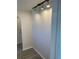 Neutral hallway with updated lighting fixtures and modern gray flooring at 186 Dan River Dr, Spring Hill, FL 34606