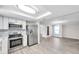 Modern kitchen with stainless steel appliances, white cabinets, and hardwood floors at 186 Dan River Dr, Spring Hill, FL 34606