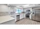 Modern kitchen with white cabinets, stainless steel appliances, and light countertops at 186 Dan River Dr, Spring Hill, FL 34606