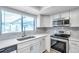 Beautifully updated kitchen featuring stainless steel appliances, white cabinets, and modern countertops at 186 Dan River Dr, Spring Hill, FL 34606