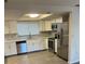 Modern kitchen featuring white cabinets, stainless steel appliances, and quartz countertops at 186 Dan River Dr, Spring Hill, FL 34606
