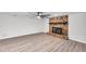 Large living area with stone fireplace, ceiling fan, and light gray flooring at 186 Dan River Dr, Spring Hill, FL 34606