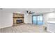 Open living room with stone fireplace and sliding glass doors to sunroom at 186 Dan River Dr, Spring Hill, FL 34606