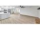 Spacious living room with light gray flooring and views into the kitchen area at 186 Dan River Dr, Spring Hill, FL 34606