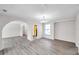 Open living room with hardwood floors, arched doorways, and plenty of natural light at 186 Dan River Dr, Spring Hill, FL 34606