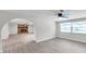 Spacious living area featuring stone fireplace, neutral walls, modern flooring, and backyard view at 186 Dan River Dr, Spring Hill, FL 34606