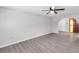 Bright living room features hardwood flooring, a ceiling fan, and views of the front entry at 186 Dan River Dr, Spring Hill, FL 34606